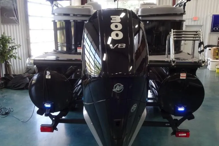 Slide: The Image of 2024 Regency 250 LE3 boat with powerful Mercury 300 V8 engine in a showroom. - 6