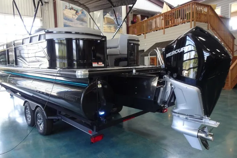 Slide: The Image of 2024 Regency 250 LE3 pontoon boat with Mercury outboard motor in showroom. - 7