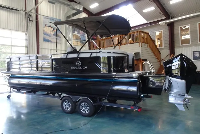 Slide: The Image of 2024 Regency 250 LE3 pontoon boat in showroom, featuring sleek design and powerful engine. - 8