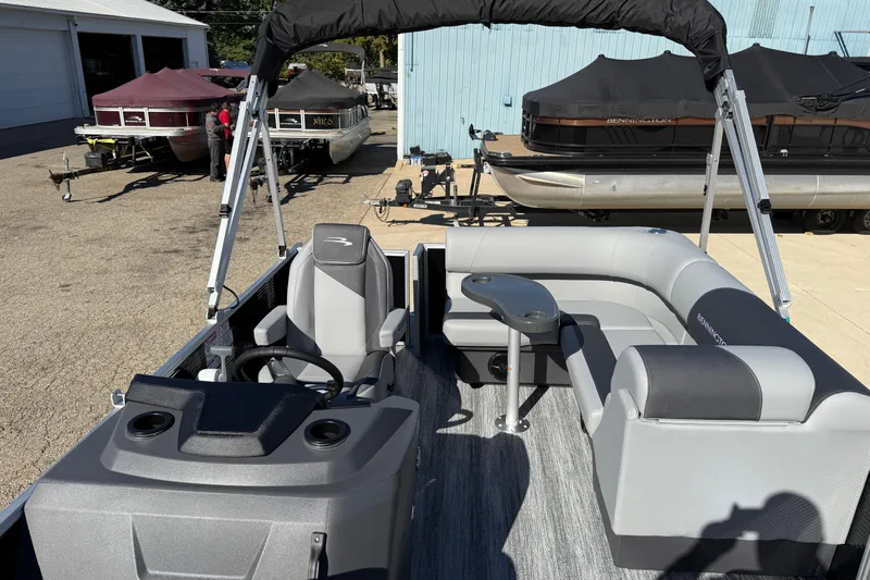Slide: The Image of 2026 Bennington 168 SF Electric pontoon boat with gray seating and steering console. - 13