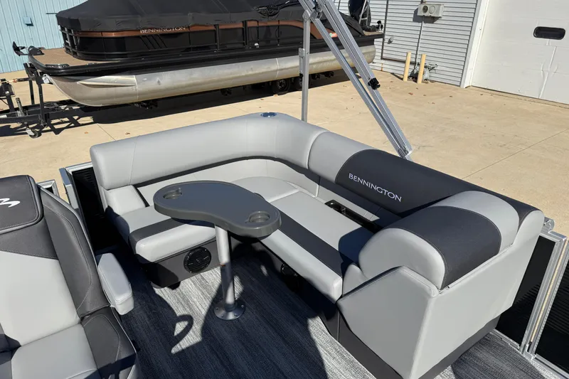 Slide: The Image of 2026 Bennington 168 SF Electric pontoon boat with gray seating and table, docked outdoors. - 15