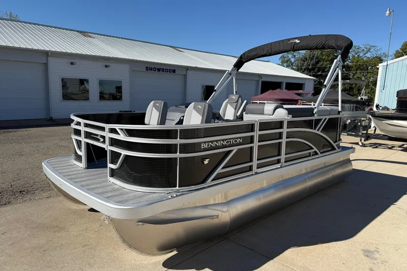 Slide: The Image of 2026 Bennington 168 SF Electric pontoon boat outside showroom on sunny day. - 3