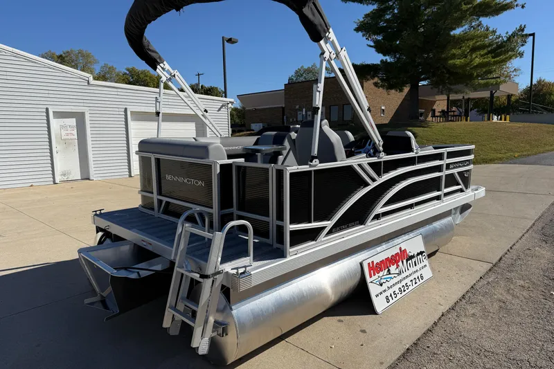 Slide: The Image of 2026 Bennington 168 SF Electric pontoon boat parked outdoors, showcasing sleek design and modern features. - 7