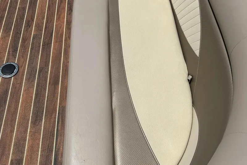 Slide: The Image of 2014 Crest 230 Crest II SLC boat interior with wood flooring and beige seating. - 13