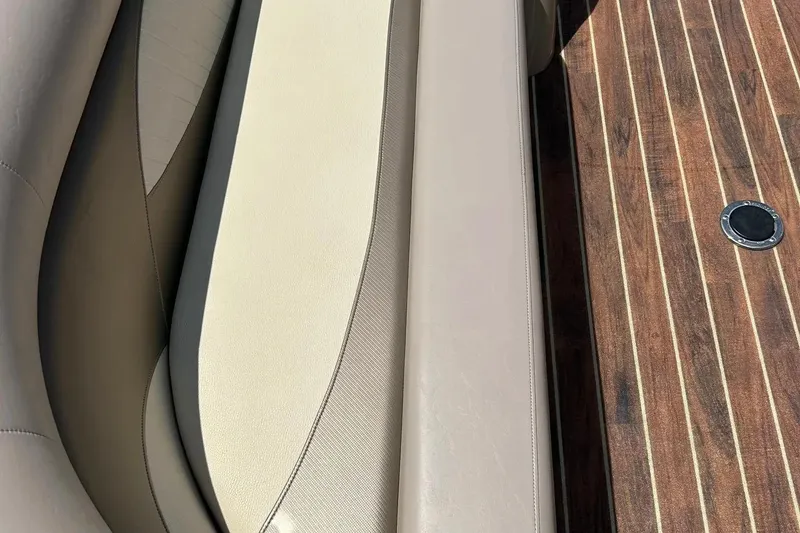 Slide: The Image of 2014 Crest 230 Crest II SLC boat interior with beige seating and wood flooring. - 14