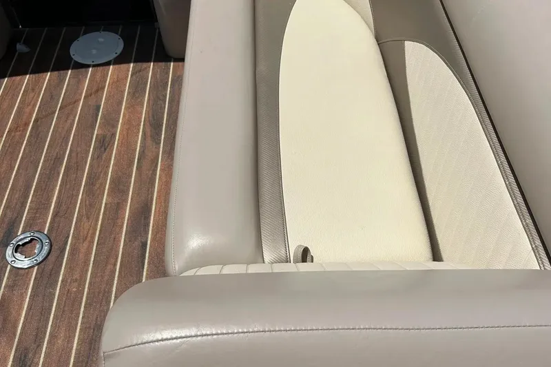 Slide: The Image of 2014 Crest 230 Crest II SLC boat interior with beige seating and wood-patterned flooring. - 17