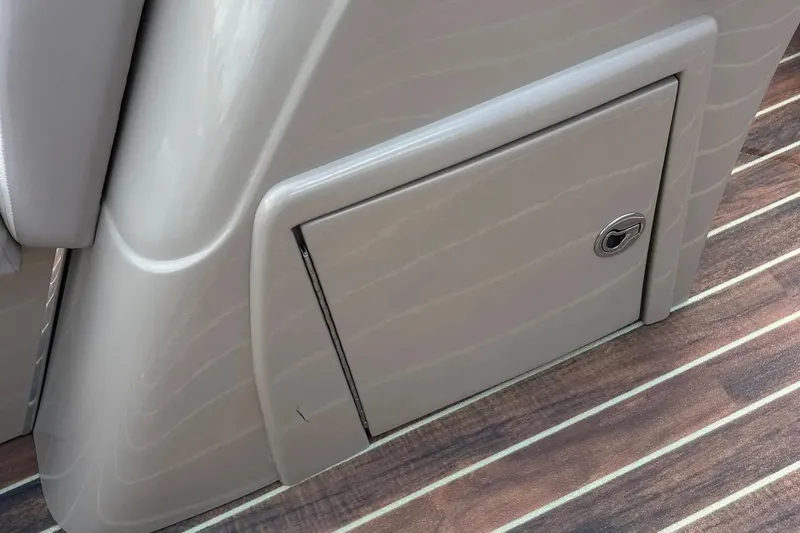 Slide: The Image of 2014 Crest 230 Crest II SLC boat storage compartment with wood-patterned flooring. - 21
