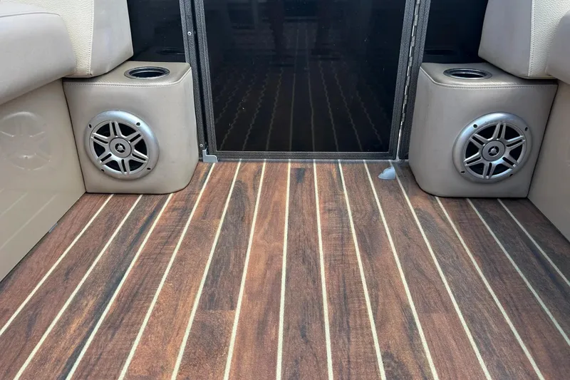 Slide: The Image of 2014 Crest 230 Crest II SLC boat interior with wood flooring and built-in speakers. - 23