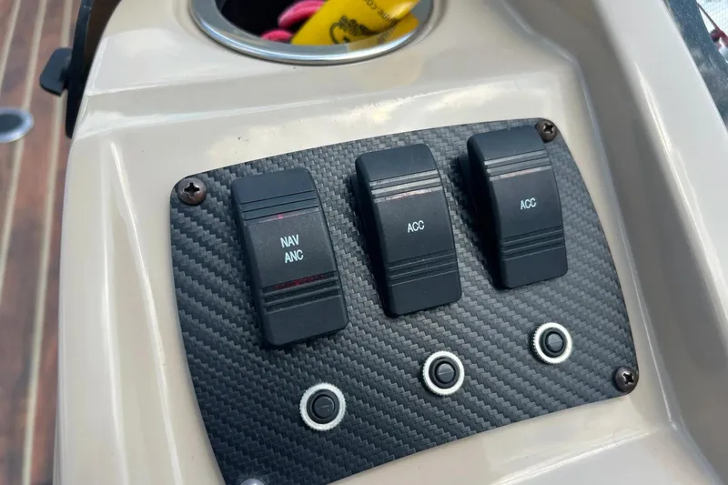 Slide: The Image of Control panel of 2014 Crest 230 Crest II SLC boat with switches and buttons. - 26