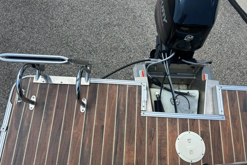 Slide: The Image of 2014 Crest 230 Crest II SLC boat with Mercury outboard motor and wooden deck. - 30