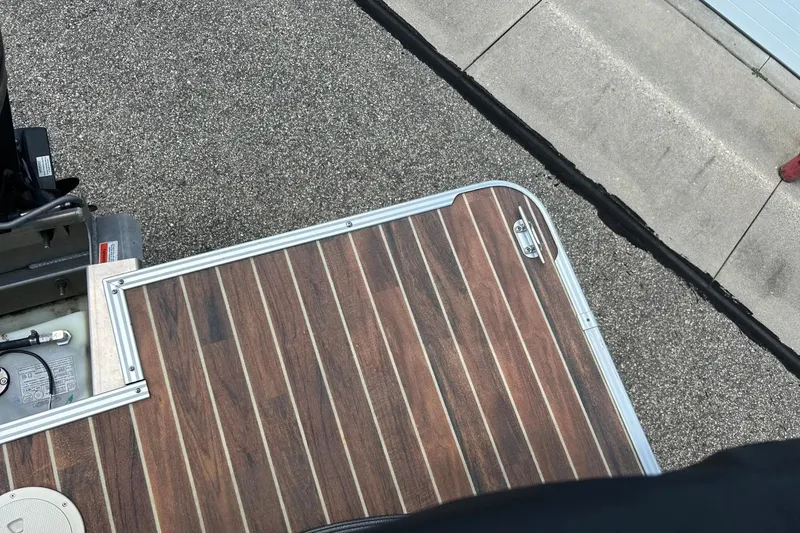 Slide: The Image of 2014 Crest 230 Crest II SLC boat deck with wood finish and metal trim. - 31