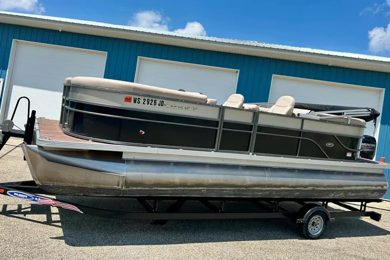 Slide: The Image of 2014 Crest 230 Crest II SLC pontoon boat on trailer, parked near blue building. - 32