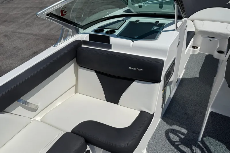 Slide: The Image of 2019 MasterCraft XT22 boat interior with black and white seating. - 10