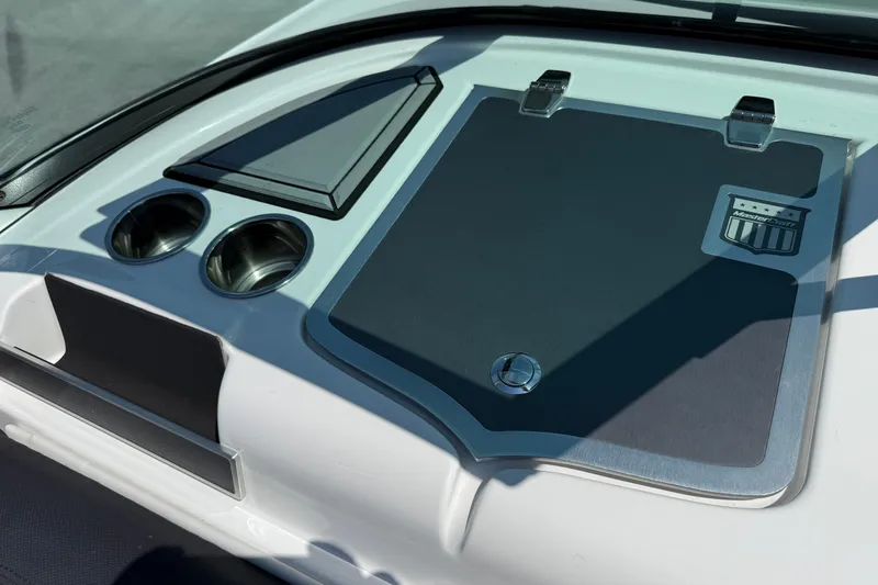 Slide: The Image of 2019 MasterCraft XT22 dashboard with cup holders and storage compartment. - 11