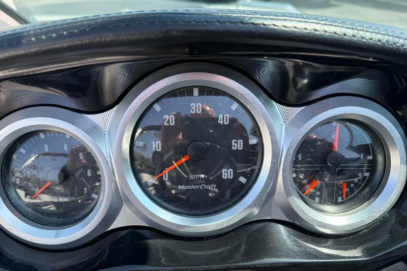Slide: The Image of Dashboard of a 2019 MasterCraft XT22 boat showing speedometer and gauges. - 14