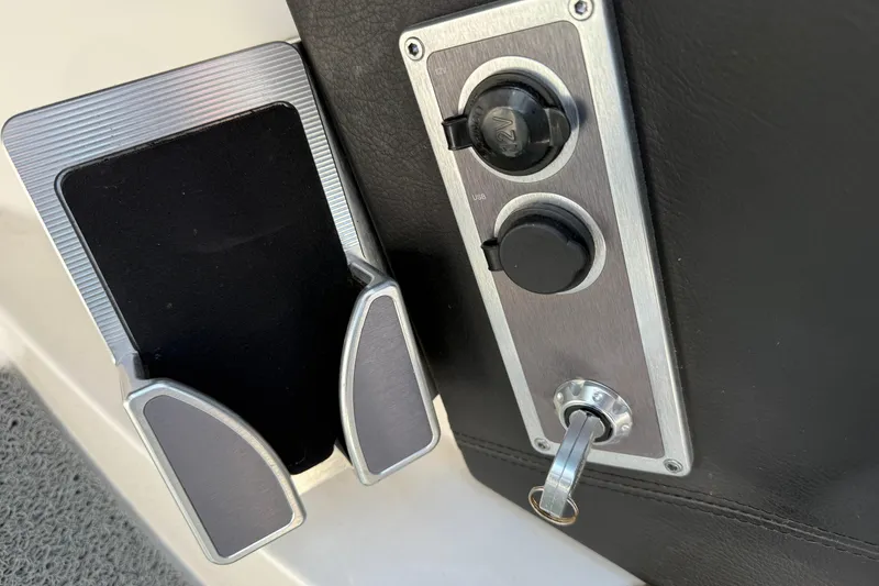 Slide: The Image of 2019 MasterCraft XT22 boat control panel with USB port and phone holder. - 15