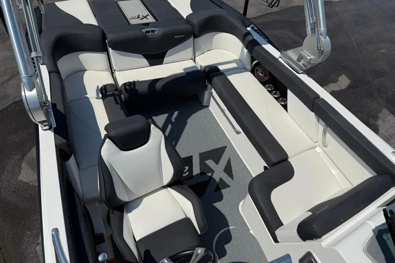 Slide: The Image of 2019 MasterCraft XT22 boat interior with sleek black and white seating and modern design. - 19