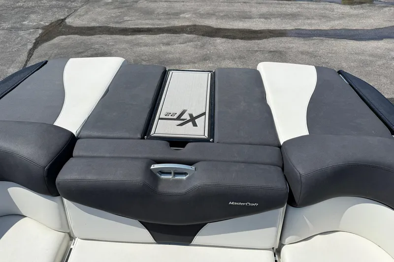 Slide: The Image of 2019 MasterCraft XT22 boat interior with sleek black and white upholstery design. - 23