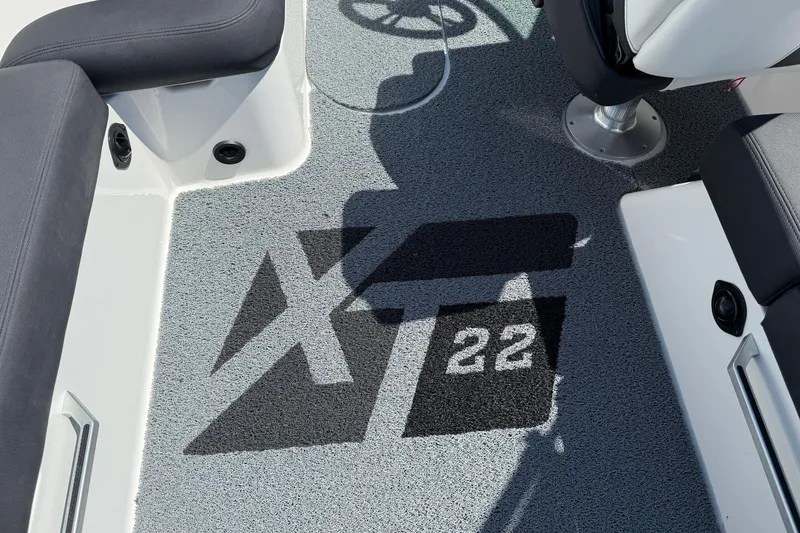Slide: The Image of 2019 MasterCraft XT22 boat interior with logo on carpeted floor. - 24