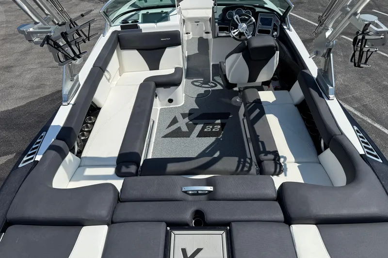 Slide: The Image of 2019 MasterCraft XT22 boat interior with sleek seating and modern dashboard design. - 25