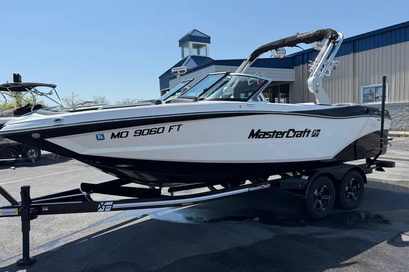 Slide: The Image of 2019 MasterCraft XT22 boat on trailer, parked outside a building. - 6