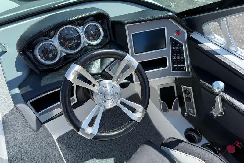 Slide: The Image of 2019 MasterCraft XT22 boat dashboard with steering wheel and control panel. - 9