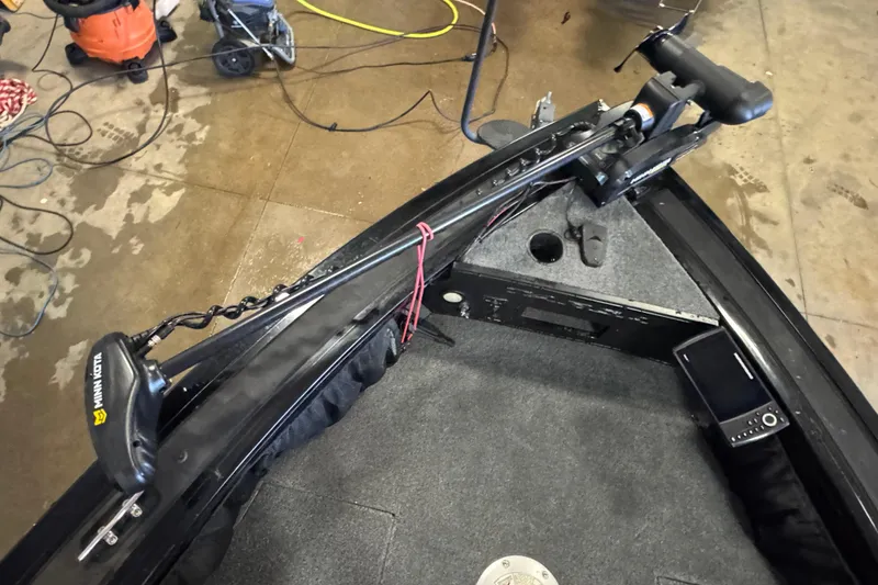 Slide: The Image of 2019 Tracker Targa V-18 WT boat interior with four gray seats in a workshop. - 13