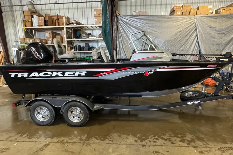 Slide: The Image of 2019 Tracker Targa V-18 WT boat with Mercury engine in a garage setting. - 3