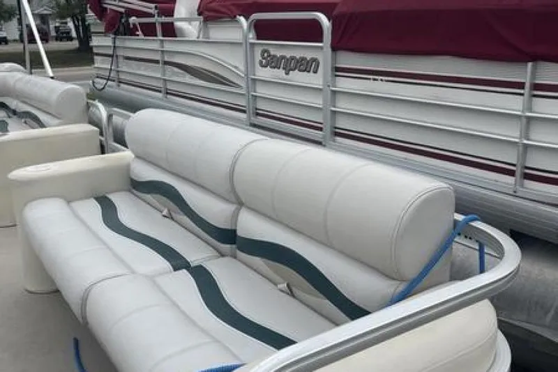 Slide: The Image of 1999 Bennington twin-toon boat with white seating and maroon cover. - 10