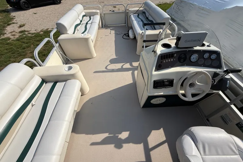 Slide: The Image of 1999 Bennington Twin-Toon pontoon boat interior with seating and Garmin navigation system. - 18