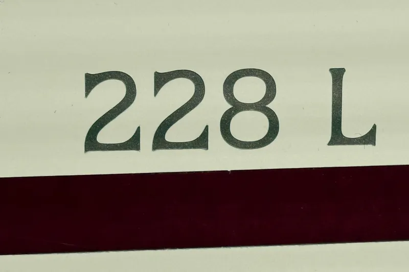 Slide: The Image of Close-up of '228 L' text on 1999 Bennington Twin-Toon boat. - 22