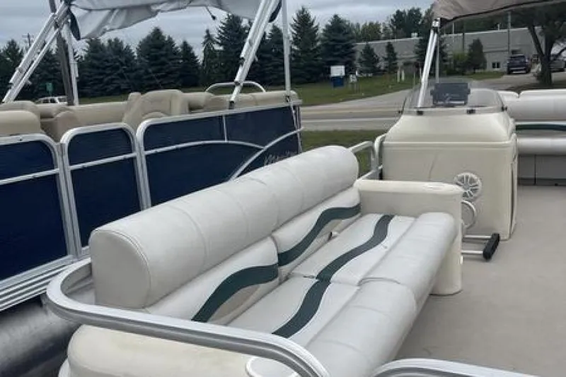 Slide: The Image of 1999 Bennington Twin-Toon pontoon boat with white seating and blue accents. - 8
