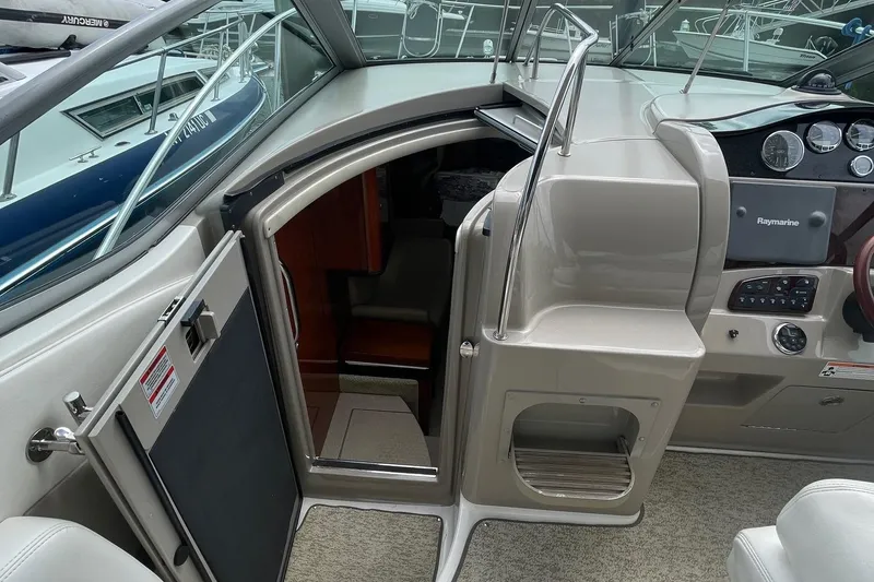Slide: The Image of 2007 Sea Ray 290 Sundancer cabin entrance with helm and control panel. - 10