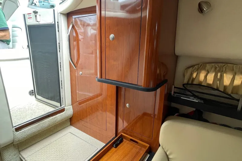 Slide: The Image of 2007 Sea Ray 290 Sundancer cabin interior with wooden cabinetry and seating area. - 14