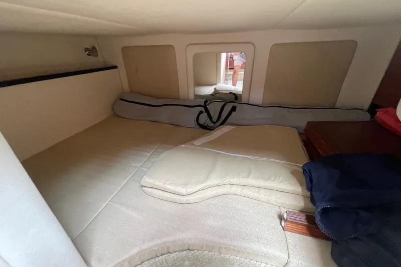 Slide: The Image of 2007 Sea Ray 290 Sundancer cabin interior with beige cushions and storage space. - 15