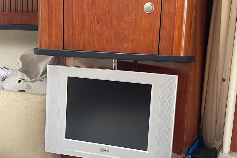 Slide: The Image of Interior of 2007 Sea Ray 290 Sundancer with wood cabinet and mounted LG TV. - 17