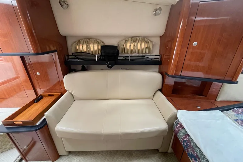 Slide: The Image of Interior of 2007 Sea Ray 290 Sundancer with beige sofa and wooden cabinetry. - 18