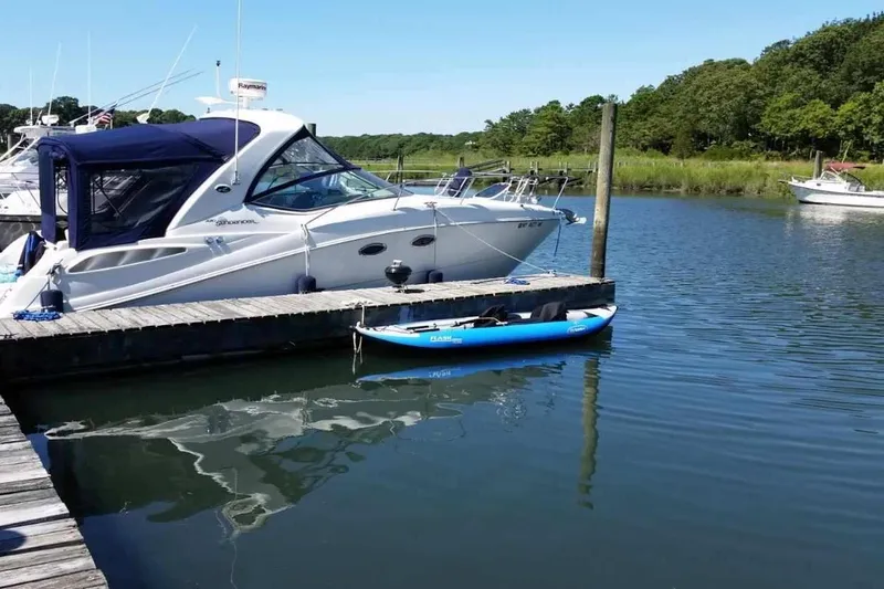 Slide: The Image of 2007 Sea Ray 290 Sundancer docked in a serene marina setting. - 23