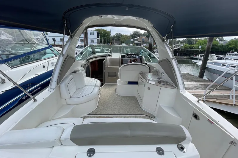 Slide: The Image of 2007 Sea Ray 290 Sundancer interior with seating and helm, docked at marina. - 4