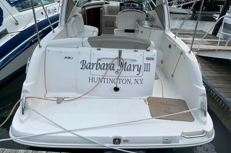 Slide: The Image of 2007 Sea Ray 290 Sundancer docked, rear view with seating and welcome mat. - 5