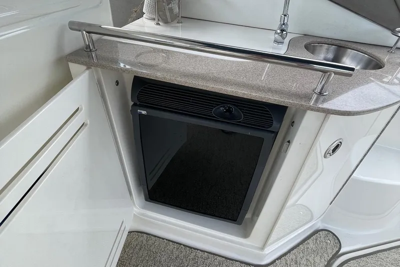 Slide: The Image of 2007 Sea Ray 290 Sundancer kitchenette with sink and mini fridge. - 8