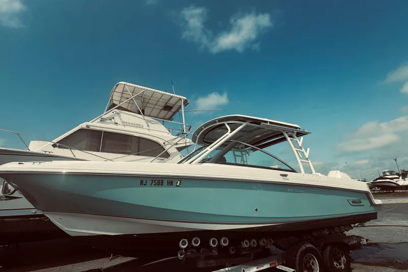 Slide: The Image of 2020 Boston Whaler 270 Vantage boat on trailer under clear blue sky. - 1