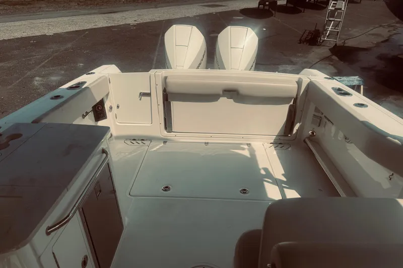 Slide: The Image of 2020 Boston Whaler 270 Vantage boat interior with dual engines, spacious deck, and seating area. - 12