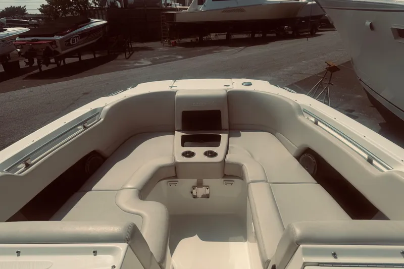 Slide: The Image of 2020 Boston Whaler 270 Vantage boat interior with cushioned seating and cup holders. - 14