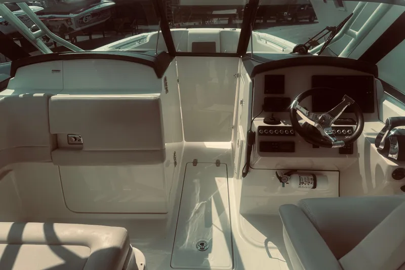 Slide: The Image of 2020 Boston Whaler 270 Vantage boat interior with steering wheel and control panel. - 15