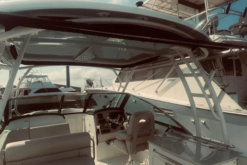 Slide: The Image of 2020 Boston Whaler 270 Vantage boat interior with helm and seating, docked at marina. - 20