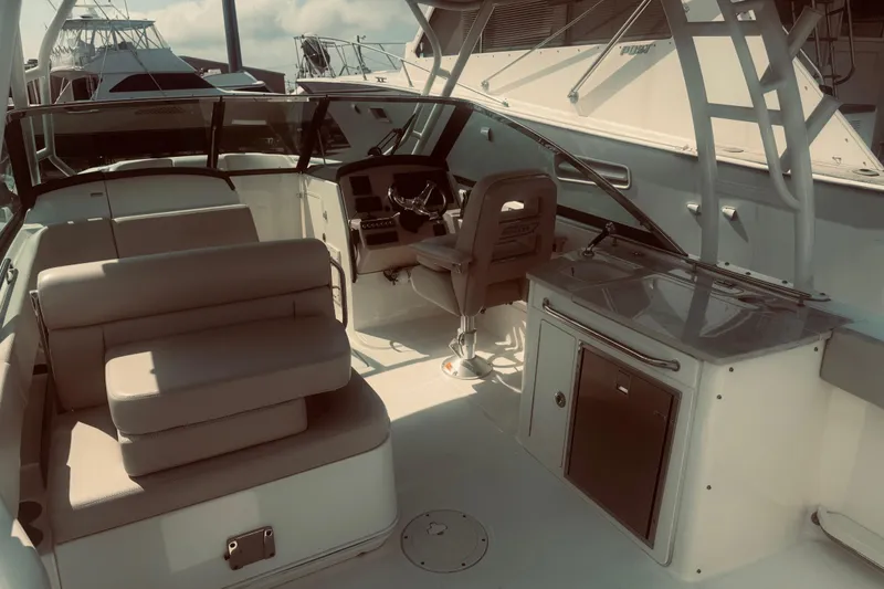 Slide: The Image of 2020 Boston Whaler 270 Vantage interior with seating and helm, docked at marina. - 21