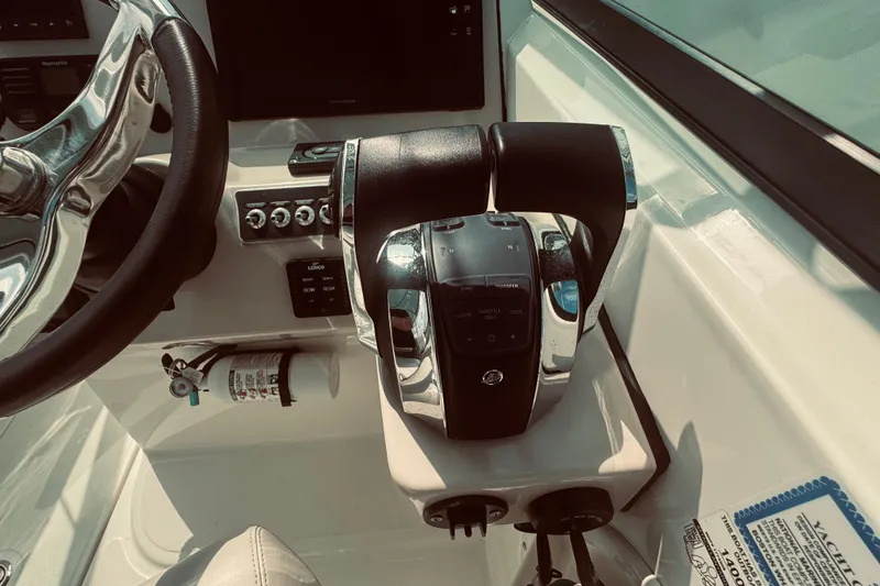 Slide: The Image of 2020 Boston Whaler 270 Vantage helm with steering wheel and throttle controls. - 24