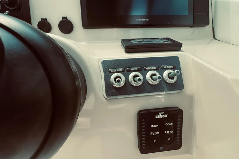 Slide: The Image of Control panel of a 2020 Boston Whaler 270 Vantage boat with switches and Lenco trim tab. - 29