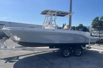 The Image of 2022 Trophy T22 boat on trailer, parked outdoors under clear blue sky. - 0
